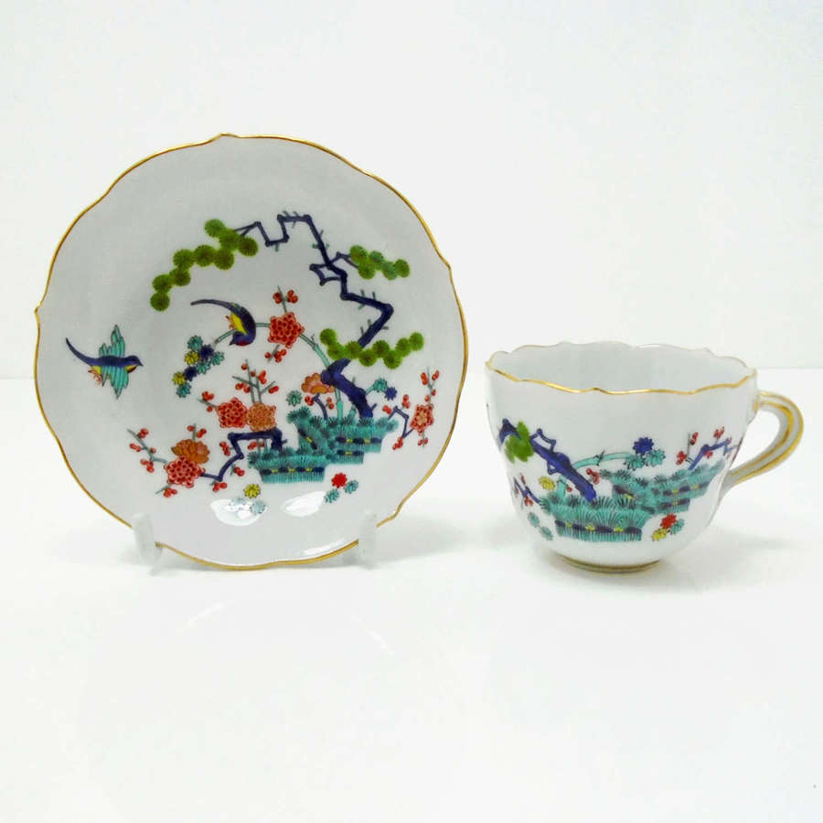 Meissen porcelain demitasse painted in polychrome enamels.